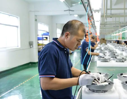 Precision manufacturing of commercial lighting fixtures in a modern factory setting.